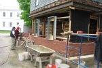 North wall with stone veneer foundation, double wythe brick wall and repaired window frames