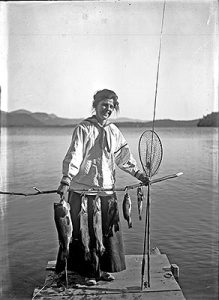 Photograph of Woman on dock with fish and gear
Poultney Historical Society Collections